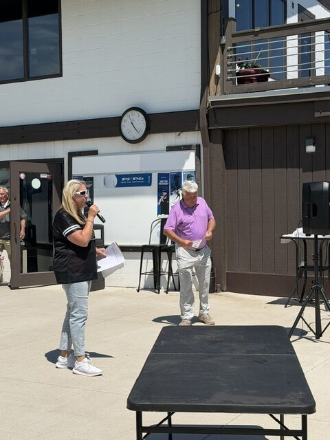 April gives a welcome speech to golfers