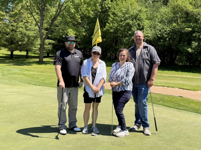 Golfers posed on the green